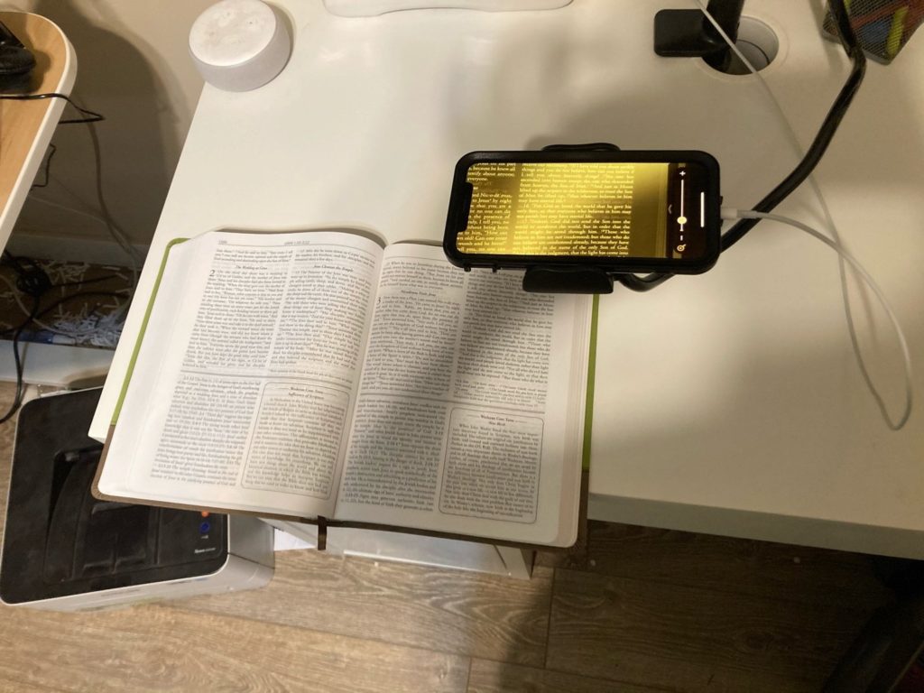 top view of a wesley study bible underneath an iphone with the magnifier active