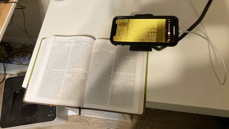 top view of a wesley study bible underneath an iphone with the magnifier active